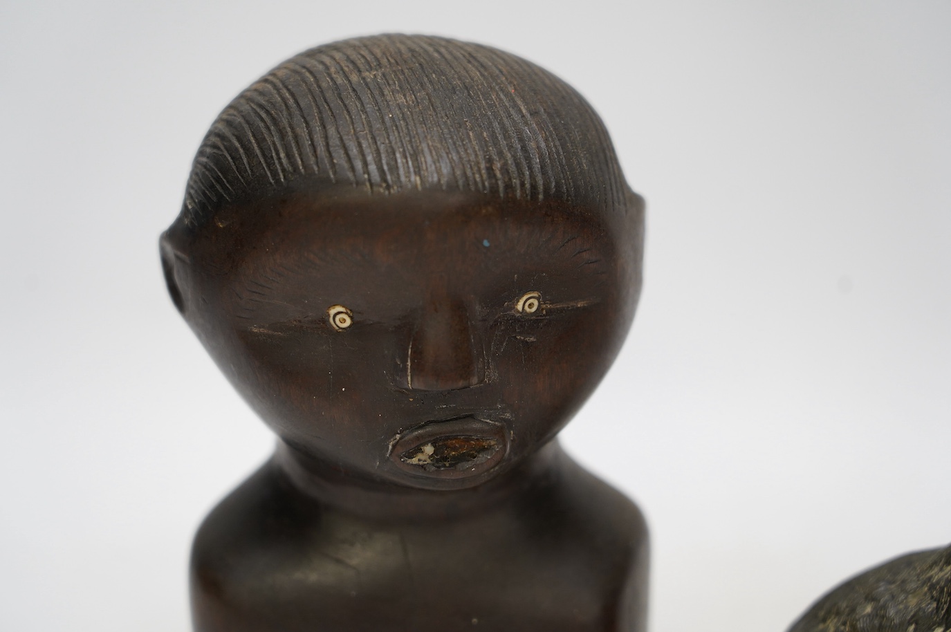 A bronze polar bear paperweight and an African tribal carved wood bust, 17cm high. Condition - fair, some splits to the bust